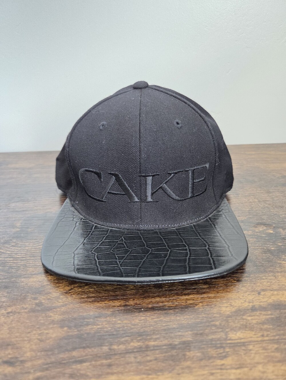 CAKE Black Leather Snapback Duck Bill Cap Sleek Glossy Streetwear Nightclub Wool